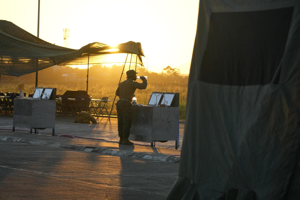 A U.S. service man drinks water as he does his morning routine at the Lal-lo airport in Cagayan province, northern Philippines on Monday, May 6, 2024. American and Filipino troopers are currently in the area to conduct annual combat-readiness exercises called Balikatan, Tagalog for shoulder-to-shoulder. (AP Photo/Aaron Favila)