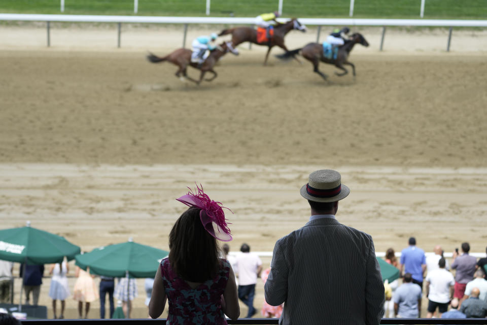 Spectators watch as the horses run the final stretch of a race ahead of the Belmont Stakes horse race, Saturday, June 10, 2023, at Belmont Park in Elmont, N.Y. (AP Photo/Mary Altaffer)