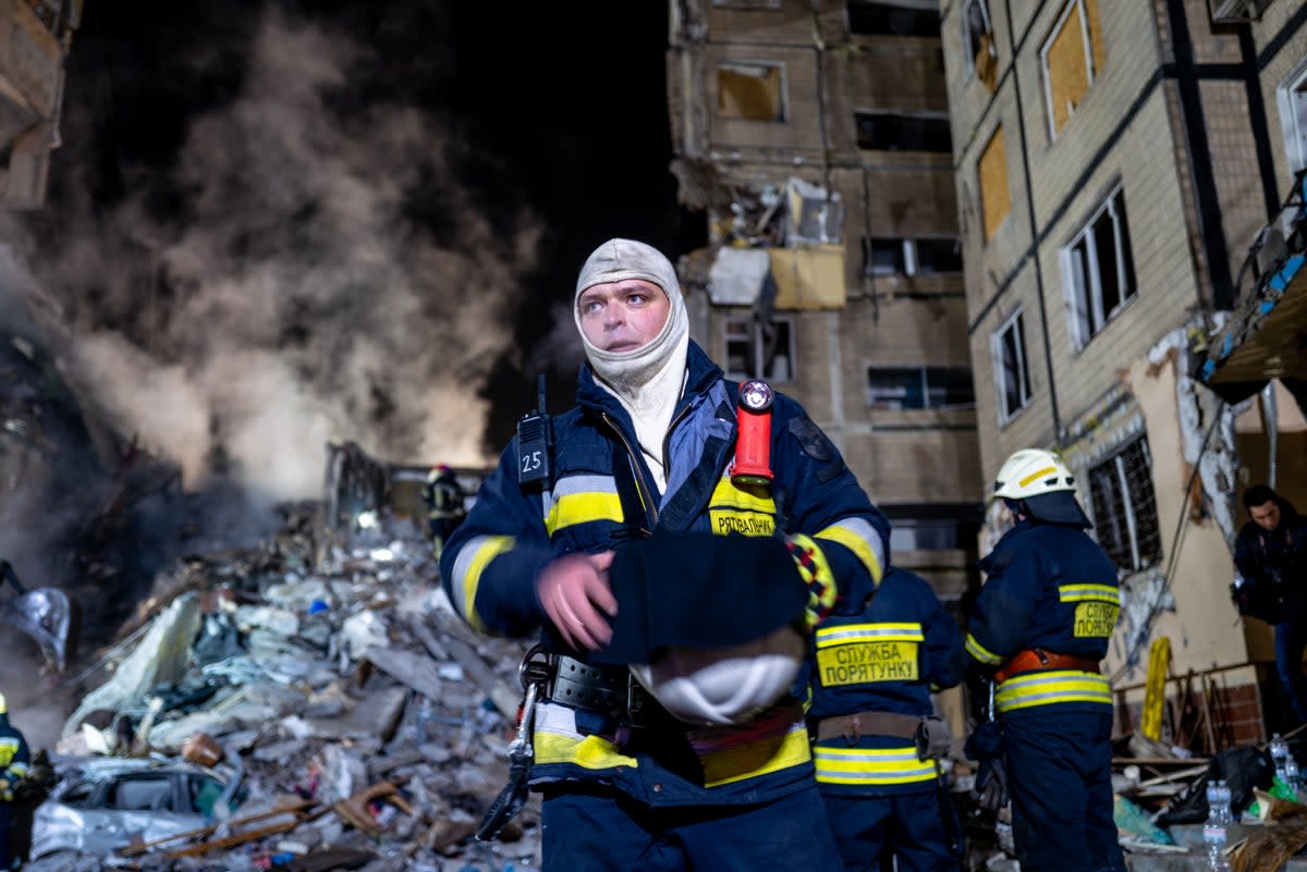 Emergency workers search the remains of the building struck in Dnipro (Getty)