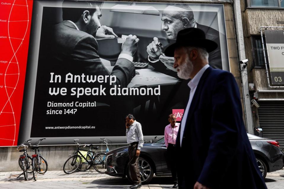 Pedestrians pass a giant advertisement for diamonds in the diamond district of Antwerp, Belgium, on Thursday, July 20, 2017. Antwerp is the most prominent diamond hub in the world. (Dario Pignatelli/Bloomberg via Getty Images)