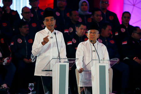 Indonesia's presidential candidate Joko Widodo (L) speaks as his running mate Ma'ruf Amin listens during a televised debate with his opponents Prabowo Subianto and Sandiaga Uno (not pictured) in Jakarta, January 17, 2019. REUTERS/Willy Kurniawan