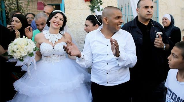 Groom Mahmoud Mansour, 26, (C) and his bride Maral Malka, 23, celebrate with friends and family before their wedding in Mahmoud's family house. Photo: Reuters.