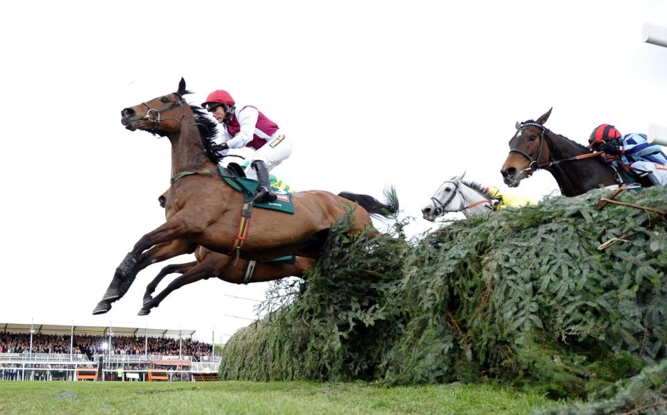 Katie Walsh, on Seabass, jumps the last ahead of eventual winner Neptune Collonges in the 2012 National