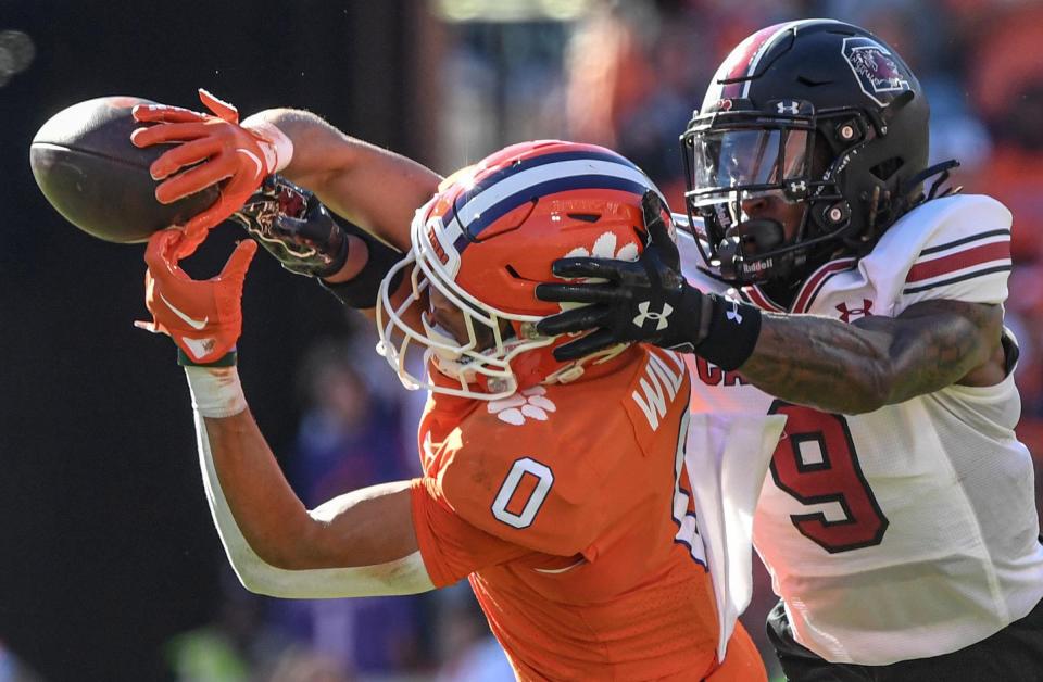 Clemson wide receiver Antonio Williams(0) catches a ball near South Carolina corner back Cam Smith (9) during the second quarter at Memorial Stadium in Clemson, South Carolina Saturday, Nov. 26, 2022.   