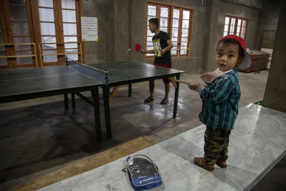 A police officer who fled Myanmar following a military coup plays table tennis at an undisclosed place in Mizoram, a state bordering Myanmar, India, Friday, March 19, 2021. Several Myanmar police officers who fled to India after defying army orders to shoot opponents of last month’s coup in their country are urging Prime Minister Narendra Modi’s government to not repatriate them and provide them political asylum on humanitarian grounds. (AP Photo/Anupam Nath)