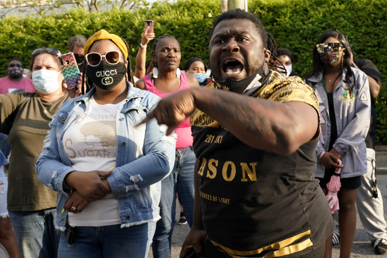 People gather outside the municipal building after at least one Pasquotank County Sheriff's deputy shot and killed a Black man while executing a search warrant, the sheriff's office said, Wednesday, April 21, 2021, in Elizabeth City, N.C. The deputy was wearing an active body camera at the time of the shooting, said Sheriff Tommy Wooten II, who declined to say how many shots the deputy fired or release any other details, citing a pending review by the State Bureau of Investigation. (AP Photo/Gerry Broome)