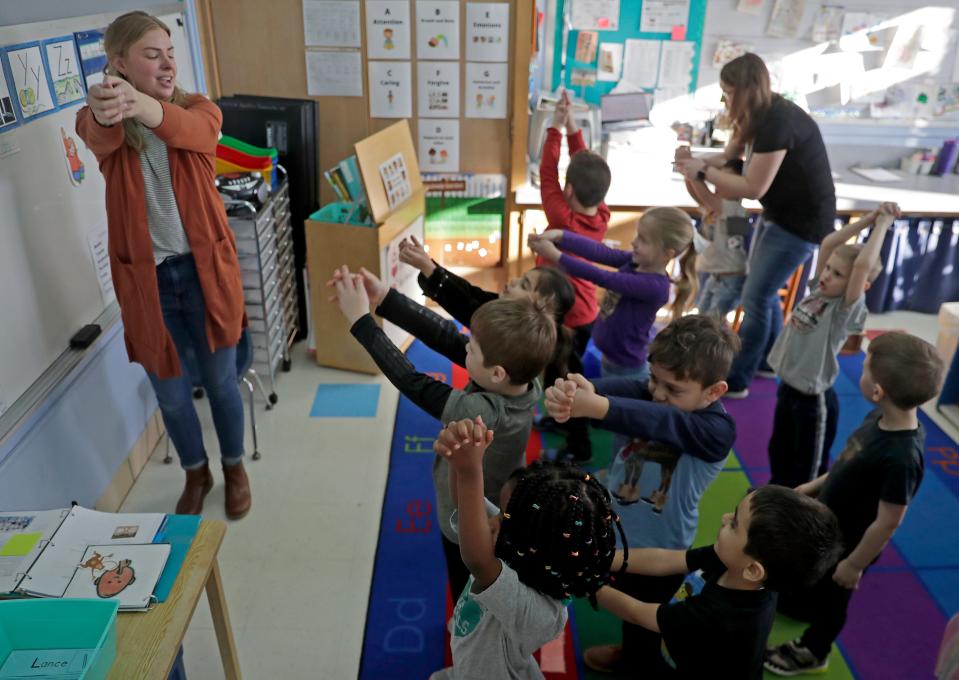 Katie Dudley leads students while stretching on Thursday, March 23, 2023  at The Community Early Learning Center in Appleton, Wis. The “Kindness Curriculum” for 4K / early education classrooms uses activities to teach mindfulness at a young age, and help with the students’ and teachers’ social-emotional health.Wm. Glasheen USA TODAY NETWORK-Wisconsin