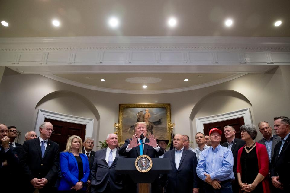 President Donald Trump, accompanied by Agriculture Secretary Sonny Perdue, center left, speaks during a meeting to support America's farmers and ranchers in the Roosevelt Room of the White House, Thursday, May 23, 2019, in Washington. (AP Photo/Andrew Harnik)