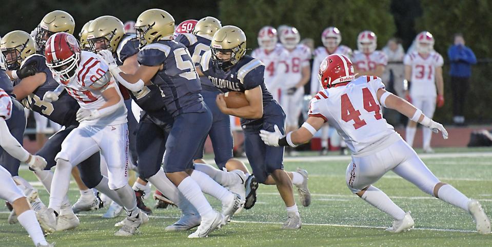 Shrewsbury's T.J. Welch looks for running room through a pack of St. John's defenders.