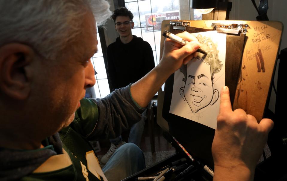 Caricature artist Bob Anderson of Pleasant Ridge draws Zarek Ludeman, 17, of Warren, during Shiver on the River at the Belle Isle Casino in Detroit, Michigan on Saturday, February 1, 2020.