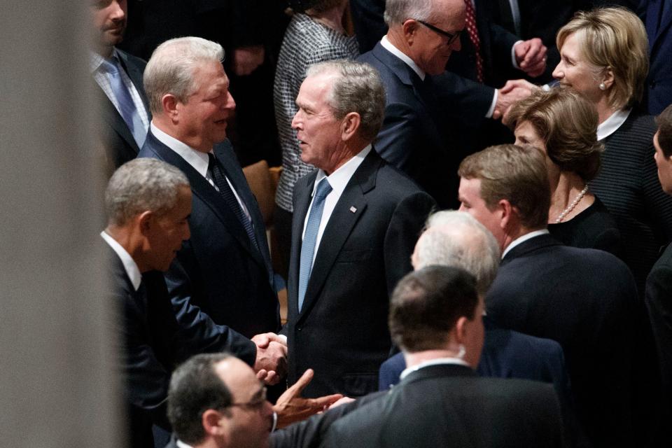 Former US President George W. Bush and former Vice President Al Gore – bitter political rivals – shake hands and John McCain's funeral at Washington National Cathedral Saturday, Sept. 1, 2018.