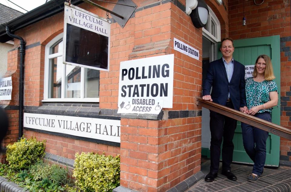 The Liberal Democrats’ by-election candidate Richard Foord (left) poses for a photograph with his wife Kate at a poll booth in Tiverton and Honiton  (PA)