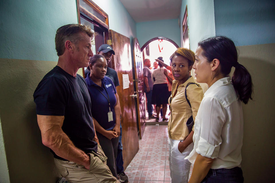 Penn and Lee confer with a team of full-time staff members and community volunteers at a CORE service site in Haiti. - Credit: Liam Storrings Photo/J/P Haitian Relief Organization 2017