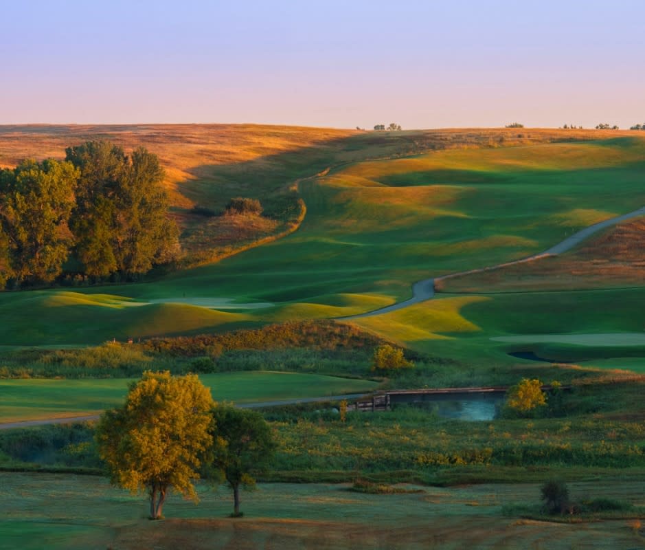 <p>Expect steep hole-to-hole elevation changes and robust Midwestern winds at Jim Engh’s undulating design located outside North Dakota’s capital of Bismarck. While it’s never the preferred position to play from, you’ll want at least one go-at-it from Hawktree’s famed black sand bunkers that, from afar, resemble a Hawaiian beach. Technically, they’re filled with coal slag, a power plant byproduct that prevents sand traps from being blown out by the area’s notorious gusts.</p>