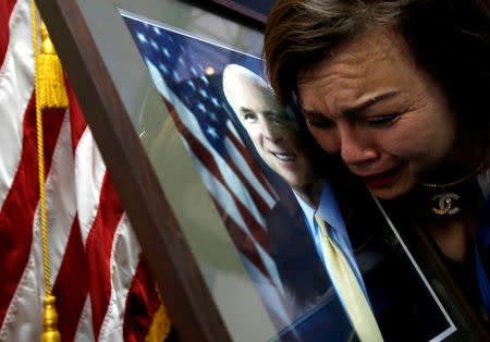 U.S. Vietnam-born citizen Mai Tran mourns near a portrait of U.S. Senator John McCain (R-AZ) after she paid respect to him at the U.S. embassy in Hanoi, Vietnam August 27, 2018. REUTERS/Kham