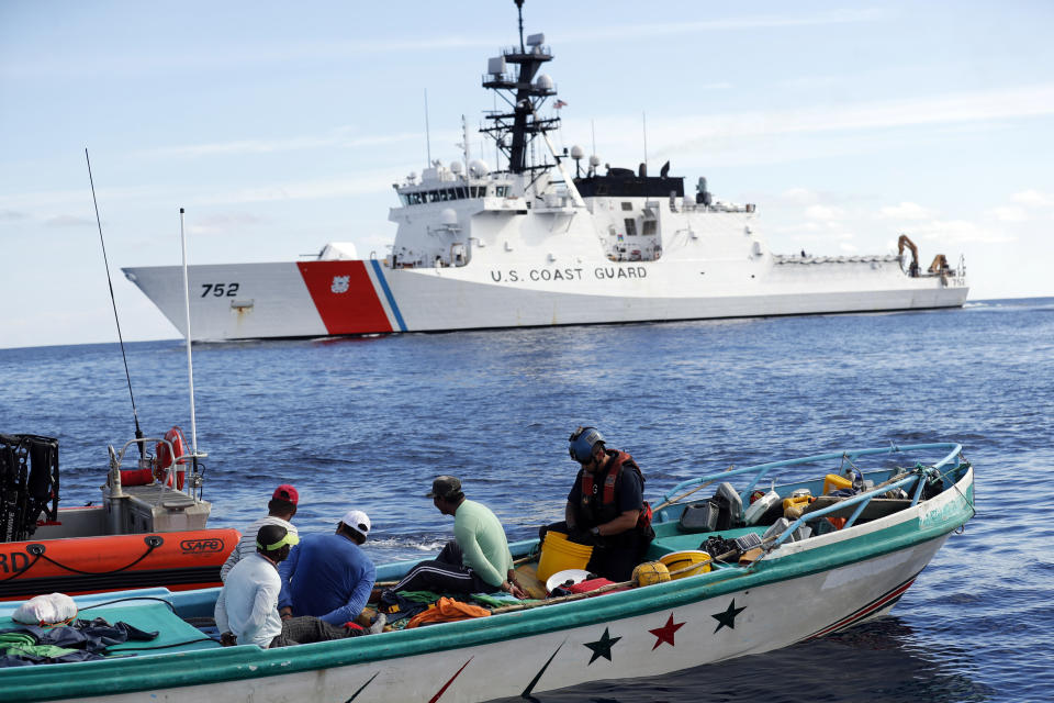 Coast Guard officers board a small fishing boat accused of smuggling cocaine in the Pacific Ocean in February 2017. (Photo: Dario Lopez-Mills/AP Photo)