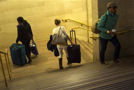 Travelers and commuters walk through Grand Central Station in New York November 27, 2013. REUTERS/Eric Thayer