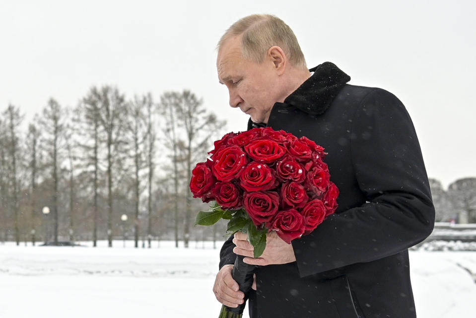 Russian President Vladimir Putin attends a wreath laying commemoration ceremony at the Piskaryovskoye Cemetery where most of the Leningrad Siege victims were buried during World War II, in St. Petersburg, Russia, Thursday, Jan. 27, 2022. People gathered to mark the 78th anniversary of the battle that lifted the Siege of Leningrad. (Alexei Nikolsky, Sputnik, Kremlin Pool Photo via AP)