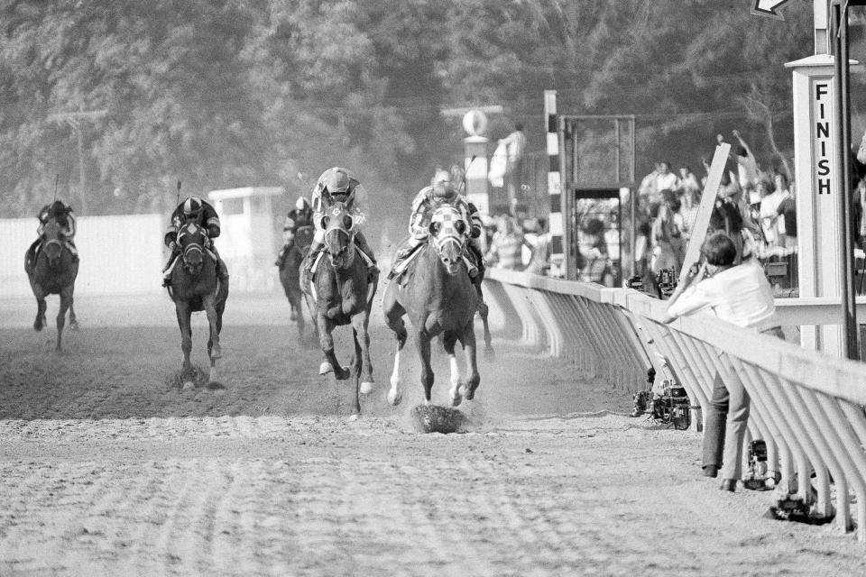 FILE - Secretariat, front, with Ron Turcotte up, wins the 98th running of the Preakness Stakes horse race, Saturday, May 19, 1973, in Baltimore. Calling Secretariat a mere Triple Crown winner probably understates his dominance. The colt with the nickname Big Red not only won the Kentucky Derby, Preakness and Belmont Stakes in 1973 — he finished each in record time. (AP Photo/File)