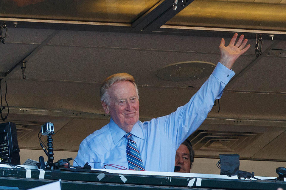 Broadcaster Vin Scully waves to the crowd during the seventh inning between the San Francisco Giants and the Los Angeles Dodgers at AT&T Park on October 2, 2016 in San Francisco, California.  / Credit: Jason O. Watson / Getty Images