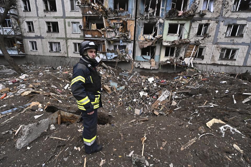 A rescuer is standing among the debris outside a multi-storey residential building that has been damaged as a result of a massive missile strike by Russian troops in Zaporizhzhia, Ukraine, on March 22, 2024.
