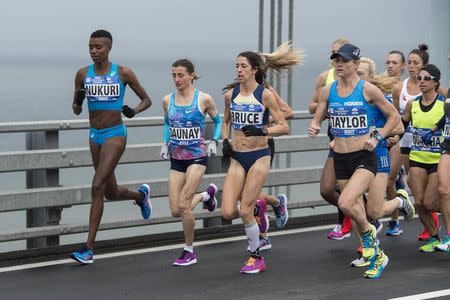 Nov 5, 2017; New York, NY, USA; Diane Nukuri (BDI) and Christelle Daunay (FRA) and Stephanie Bruce (USA) and Kellyn Taylor (USA) compete for second in the New York City marathon as they cross at the Verrazano Bridge. Mandatory Credit: Gregory J. Fisher-USA TODAY Sports