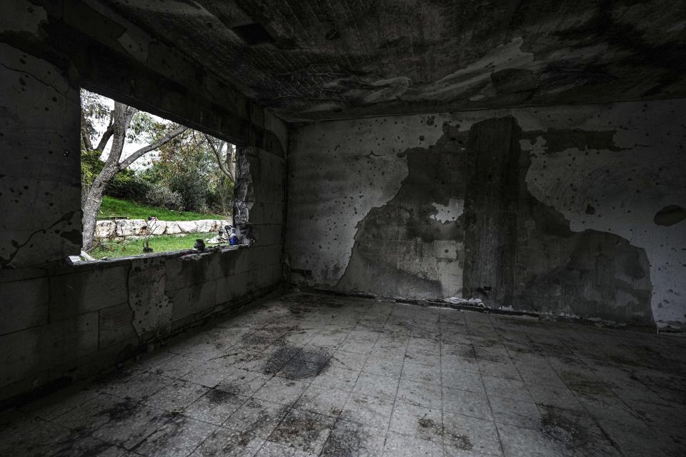 A battle-scarred home in Kibbutz Be'eri, an Israeli communal farm on the Gaza border, is seen Thursday, Jan. 11, 2024. Hamas held more than a dozen hostages in the home when it overran southern Israel on Oct. 7. At the end of an hours-long battle between the militants and Israeli forces, only two hostages survived, and relatives of the slain hostages now demand to know if their loved ones were killed by friendly fire from an Israeli tank. (AP Photo/Tsafrir Abayov)