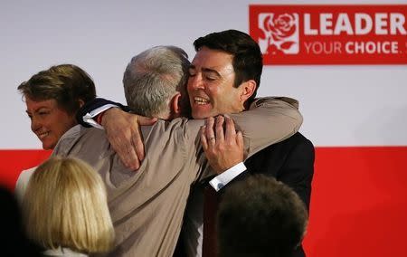 Labour Party leadership candidates Jeremy Corbyn (C) and Andy Burnham (R) embrace as Yvette Cooper walks off stage after a hustings event in Stevenage, Britain June 20, 2015. REUTERS/Darren Staples