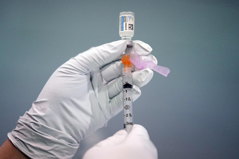 FILE - A member of the Philadelphia Fire Department prepares a dose of the Johnson & Johnson COVID-19 vaccine at a vaccination site setup in Philadelphia, on March 26, 2021. On Friday, April 29, The Associated Press reported on stories circulating online incorrectly claiming a recent outbreak of unexplained hepatitis cases among children is being caused by the adenovirus vector used in some COVID-19 vaccines, including the Johnson & Johnson shot.(AP Photo/Matt Rourke, File)