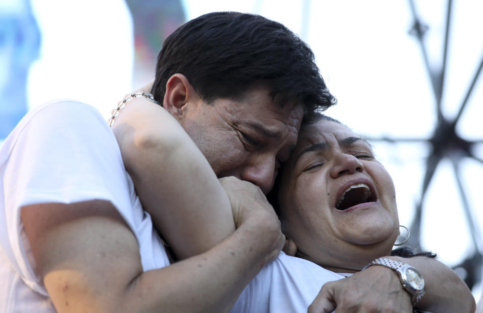 Graciela Sosa and husband her Silvino Baez lament the violent death of their son Fernando Baez Sosa, outside Congress where people gathered to demand justice one month after the death of the 18-year-old, in Buenos Aires, Argentina, Tuesday, Feb. 18, 2020. According to an attorney on the case, Baez Sosa was beaten to death by a group rugby players in the coastal city of Villa Gesell in the Buenos Aires province in eastern Argentina. (AP Photo/Natacha Pisarenko)