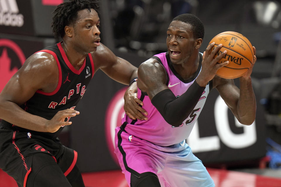 Miami Heat guard Kendrick Nunn (25) looks to pass around Toronto Raptors forward OG Anunoby (3) during the second half of an NBA basketball game Wednesday, Jan. 20, 2021, in Tampa, Fla. (AP Photo/Chris O'Meara)