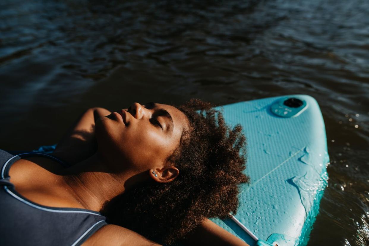 woman relaxing on paddleboard