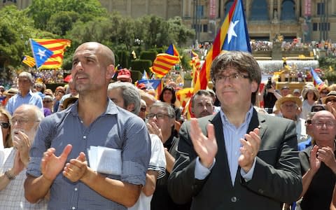 Manchester City's head coach Pep Guardiola (L) and Catalonian president Carles Puigdemont (R), during the demonstration to support the referendum - Credit: EPA/TONI ALBIR