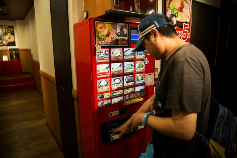 At the Ichiran noodle chain, customers order from a vending machine and eat in a partitioned booth