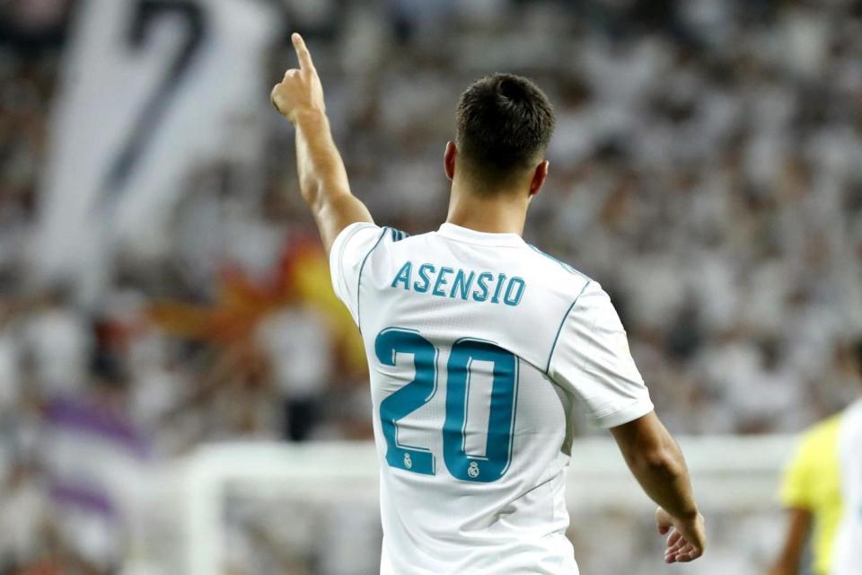 On target: Asensio celebrates his brilliant goal against Barca at the Bernabeu (EPA)