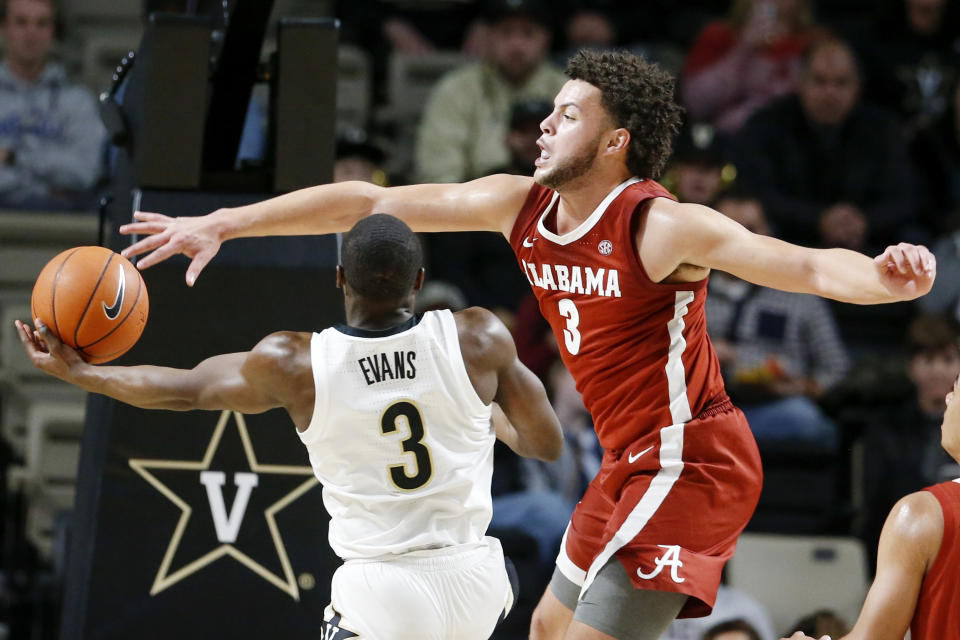 Vanderbilt guard Maxwell Evans, left, drives against Alabama forward Alex Reese in the second half of an NCAA college basketball game Wednesday, Jan. 22, 2020, in Nashville, Tenn. Alabama won 77-62. (AP Photo/Mark Humphrey)