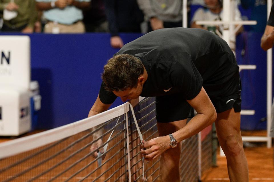 Juan Martin Del Potro (pictured) hangs his headband and kisses it over the net.