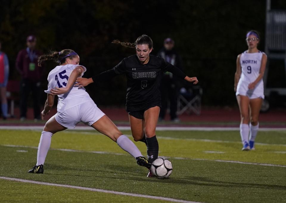 Albertus' Grace Burns (5) works the ball around Clarkstown North's Hannah McKiverkin (15) during their 1-0 win over Clarkstown North in the Section 1 Class A soccer championship game at Nyack High School in Nyack on Saturday, October 29, 2022.