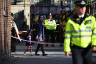 <p>A woman walks with her child past police cordon near Parsons Green tube station in London, Britain, Sept. 15, 2017. (Photo: Hannah McKay/Reuters) </p>