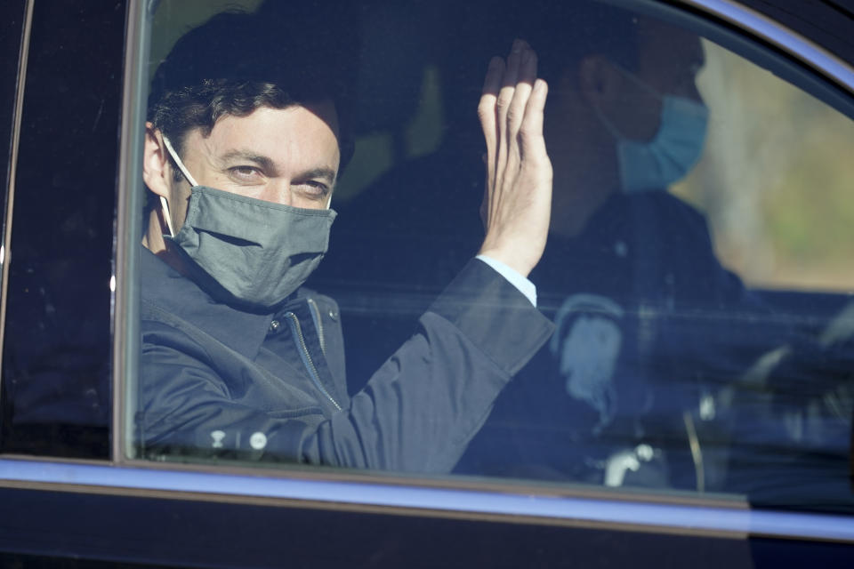 Democratic nominee for U.S. Senate from Georgia Jon Ossoff waves as he leaves a polling place after voting early in Atlanta on Tuesday, Dec. 22, 2020. For the second time in three years, Jon Ossoff is campaigning in overtime. The question is whether the 33-year-old Democrat can deliver a win in a crucial Jan. 5 runoff with Republican Sen. David Perdue. (AP Photo/John Bazemore)