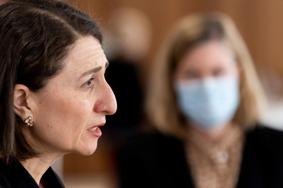 A. side profile of Gladys Berejiklian at a press conference.