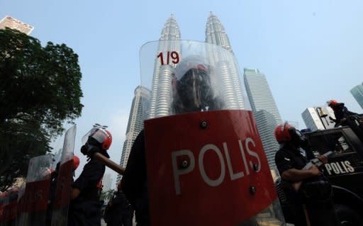 Anti-riot police stand ready to face protesters during a mass rally calling for electoral reform in Kuala Lumpur in July. Malaysia will scrap a tough 51-year-old law allowing detention without trial and ease other legislation long blamed for curbing civil liberties, Prime Minister Najib Razak has announced