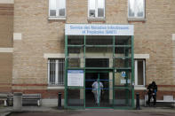 A medical staff leaves the department of Tropical Infections and diseases at the Bichat hospital, Wednesday, Jan. 29, 2020 in Paris. Countries began evacuating their citizens Wednesday from the Chinese city hardest-hit by a new virus that has now infected more people in China than were sickened in the country by SARS. France has reported four cases of the deadly new virus so far. (AP Photo/Christophe Ena)