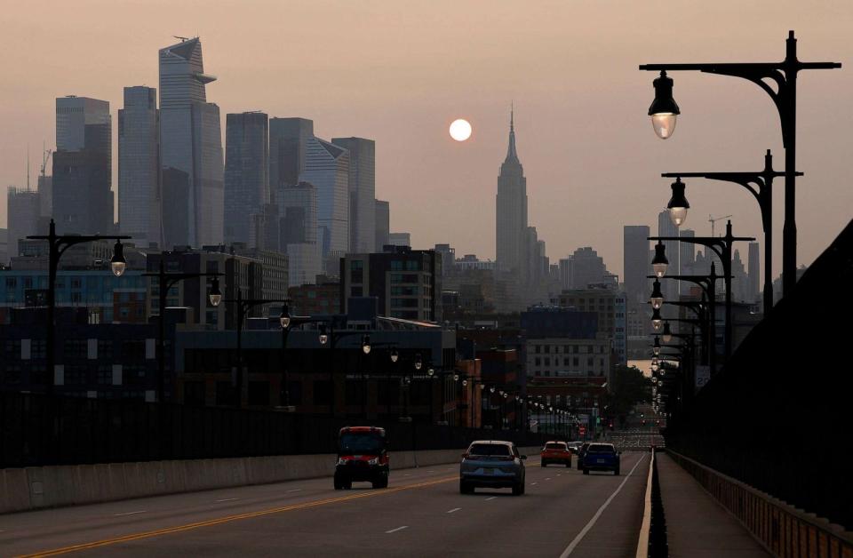 PHOTO: Wildfire smoke drifting back into the Northeast shrouds the sun as it rises behind the Empire State Building in New York City. Oct. 1, 2023, as seen from Hoboken, NJ. (Gary Hershorn/ABC News)