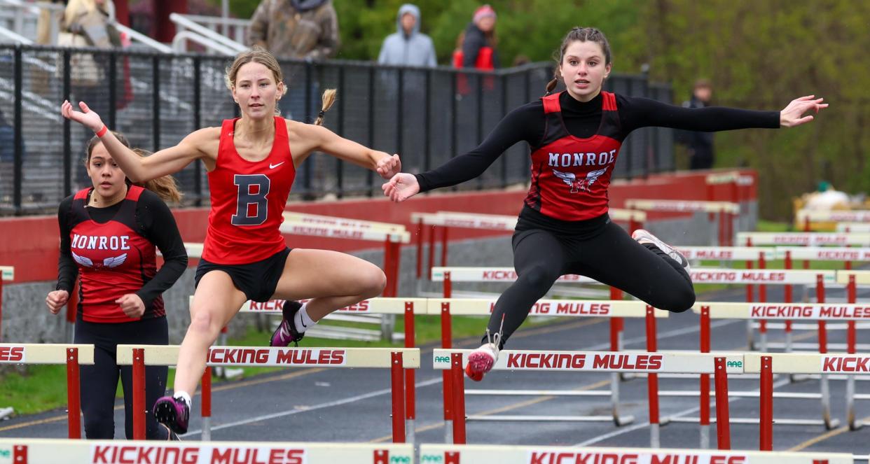 Bedford's Gabriella Pisanti and Olivia Harmon of Monroe battle for the lead in the high hurdles Tuesday.