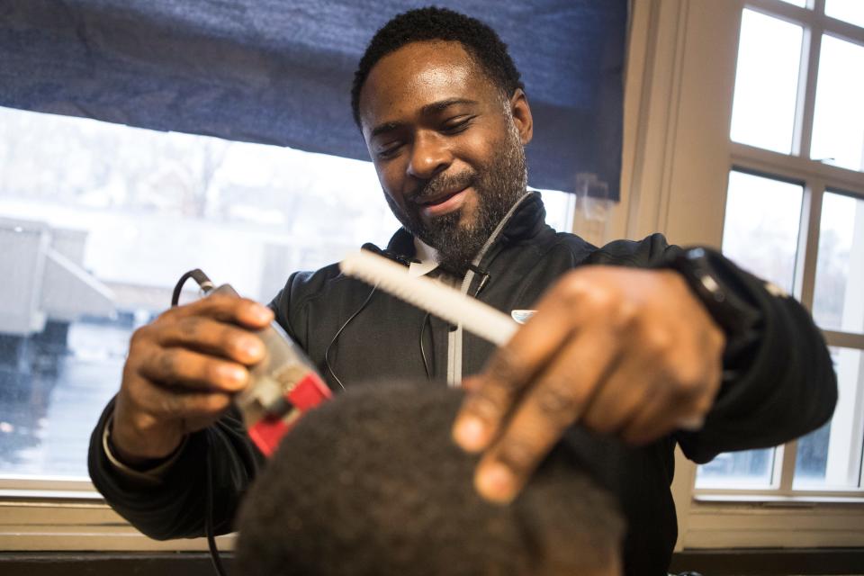 Warner Elementary Principal Terrance Newton shapes up the hair of student Brandon Ponzo on Monday, Dec. 16, 2019, at the school. The makeshift barbershop gives Newton a chance to bond with his students in a more casual setting and keep his students looking sharp.