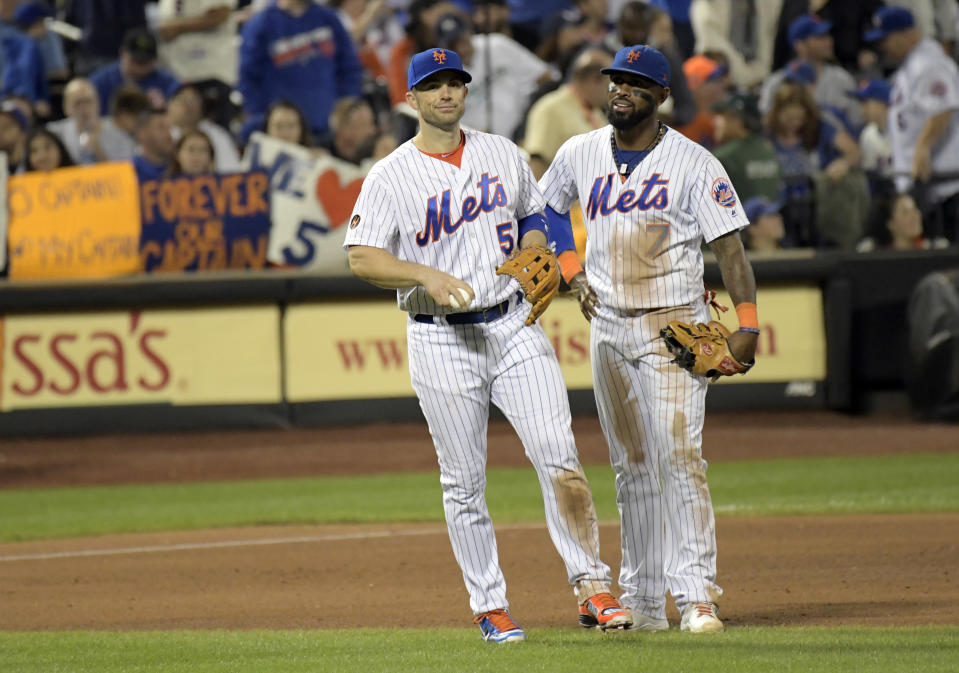 New York Mets third baseman David Wright (5) talks with shortstop Jose Reyes (7) before Wright was taken out of the baseball game during the fifth inning Saturday, Sept. 29, 2018, in New York. (AP Photo/Bill Kostroun)