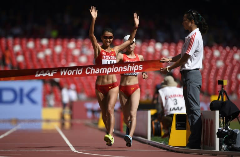 China's Liu Hong (L) wins ahead of China's Lu Xiuzhi in the women's 20 kilometres race walk final at the IAAF World Championships at Beijing's Bird's Nest stadium on August 28, 2015