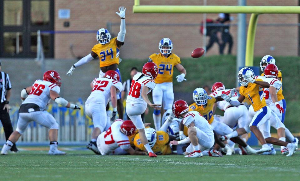 Members of the Angelo State University defense try to block an extra point attempt during a game against Simon Fraser on Saturday, Oct. 23, 2021.