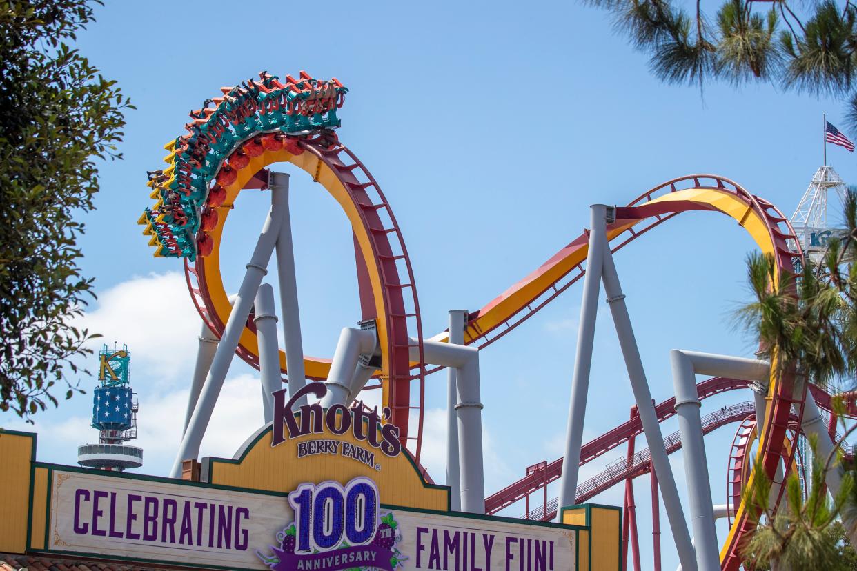 Buena Park, CA - May 29: A view of the entrance as park-goers ride the Silver Bullet roller coaster during the re-opening day at Knott's Berry Farm to the full public and celebrate the 100th anniversary of the park after the easing of coronavirus pandemic restrictions Saturday, May 29, 2021 in Buena Park, CA. This is the first time the broader public has been able to enter and enjoy the main park at Knott's Berry Farm. Knott's is also debuting a new ride called "Knots Betty Tales."